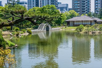 Concrete bridge across lake at Shukkeien Gardens in Hiroshima, Japan, Asia