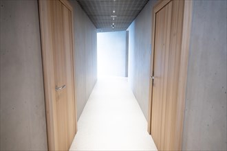 Modern Illuminated Concrete Corridor with Sunlight in Switzerland