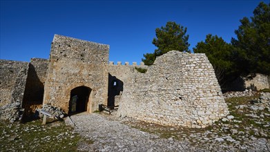 Sunny view of the entrance gate of an old fortress ruin, Chlemoutsi, High Medieval Crusader Castle,