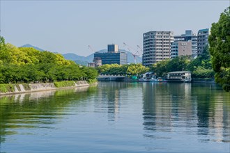 Canal through tree lined park in Hiroshima, Japan, Asia