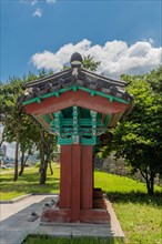 Side view of oriental information board with tiled roof at urban park in South Korea