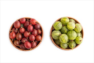 Fresh red and green gooseberry in clay bowl isolated on white background. top view, flat lay, close