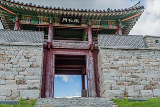 Closeup of main gate at Hongjueupseong walled town under cloudy blue sky in South Korea