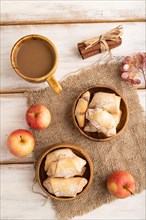 Homemade sweet cookie with apple jam and cup of coffee on white wooden background and linen textile