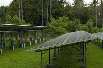 Solar power plant energy panels on tropical island Gili Air, Indonesia. Cloudy day, tropical