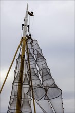 Fish traps hanging to dry on a ship's mast, Oudeschild, North Sea island, Texel, West Frisian