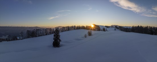 Sunset over the second Jura chain in winter, foreground contours of sinkholes, view towards the