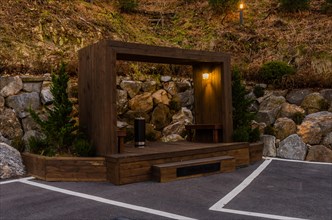 Night view of wooden outside smoking area in corner of parking lot in South Korea