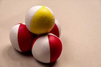 Three juggling balls in front of a light background, selective focus, studio shot, Germany, Europe