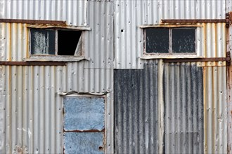 Corrugated iron panelling and windows, abandoned herring factory Djupavik, Reykjarfjoerour,