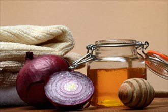 Honey in a jar and red onion, ingredients for cough syrup