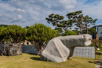 Large white boulder in natural shaped looks like phallus in public park in South Korea