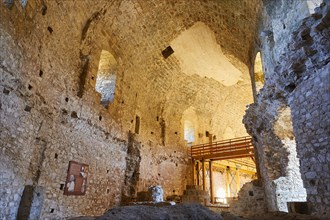 View of the interior of an old castle with vaulted ceilings and visible renovation work,