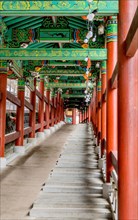 Colorful covered walkway with stairs and wheelchair ramp at Buddhist temple in South Korea