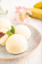 Japanese rice sweet buns mochi filled with jam and cup of coffee on a gray concrete background.