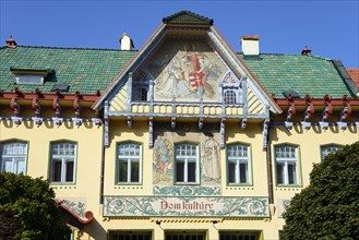 Detailed view of an Art Nouveau cultural centre with relief-like murals on a sunny day, House of