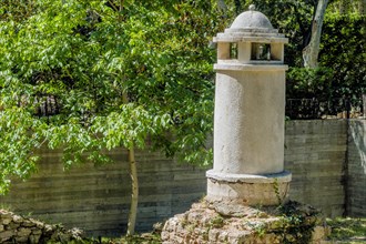 Remains of small concrete tower with dome in public park on sunny afternoon in Istanbul, Tuerkiye