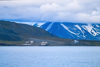 View at an old mining village on Svalbard coast with high mountains, Svalbard