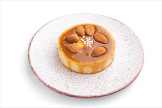 Sweet tartlets with almonds and caramel cream isolated on white background. side view, close up