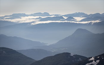 High fog between mountain peaks, view from the summit of Skala, Loen, Norway, Europe