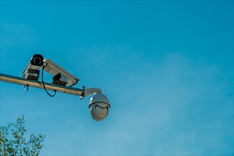 CCTV cameras on chrome pole under a beautiful blue sky
