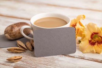 Gray paper business card mockup with orange day-lily flower and cup of coffee on white wooden