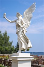 One of two sculptures, white statues, figures Floating Victorians (Angel of Peace, Goddess of