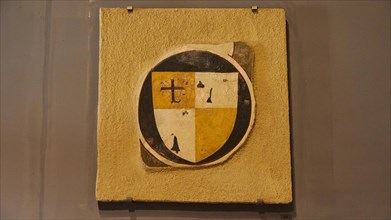 Ancient medieval coat of arms on a shield with a cross and in yellow, black and white colours,