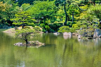 Small island in middle of lake in Shukkeien Gardens in Hiroshima, Japan, Asia