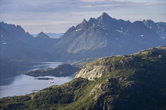 Fjord Raftsund and mountains in atmospheric evening light, view from the summit of Dronningsvarden