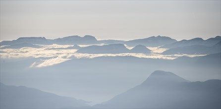 High fog between mountain peaks, view from the summit of Skala, Loen, Norway, Europe