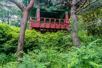 Oriental picnic pavilion on hillside in mountainous recreational forest in South Korea