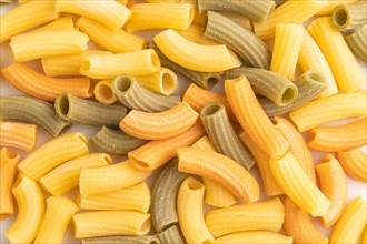 Rigatoni colored raw pasta, texture, background. Top view, flat lay