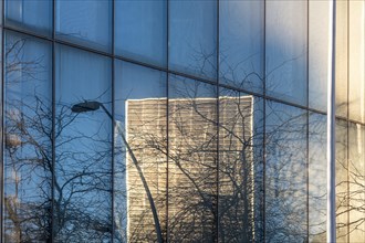 Detail of a facade with the reflection of a modern building in Poblenou in Barcelona in Spain
