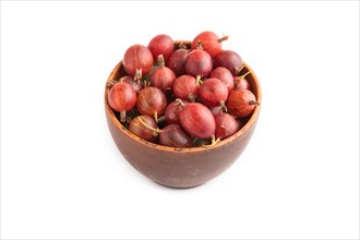 Fresh red gooseberry in clay bowl isolated on white background. side view, close up