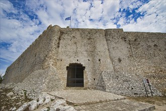 Fortress with Greek flag on a cloudy day, Chlemoutsi, High Medieval Crusader Castle, Kyllini