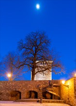 Garden of the Moellenvogtei with historic city wall and defence defence tower under the moon in the