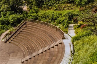 Wooden arena style seating and deck on hiking trail in recreational forest in South Korea