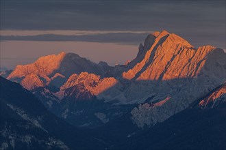 Distant view of steep mountains in the evening light, clouds, autumn, view from Wank to Karwendel