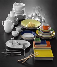Plates, cups, cutlery, coffee pot, glasses, table decoration