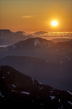 Sun setting behind the mountains, mountain panorama from the summit of Skala, Loen, Norway, Europe