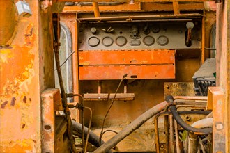 Instrument panel inside cab of old, rusted, broken down bulldozer