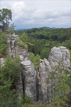 Wooded rock formations under a slightly cloudy sky, Prachovske skaly, Prachov Rocks, Bohemian