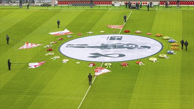 Flags of the FC Bayern fan clubs lie on the pitch in honour of Franz Beckenbauer, banner with Franz