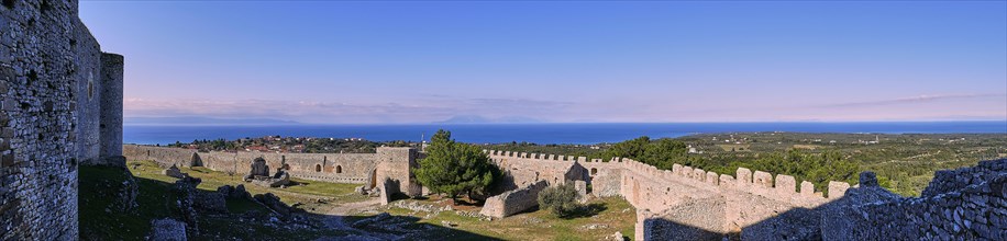 Panoramic picture, fortress walls of an old castle with a view of the sea and the blue sky,