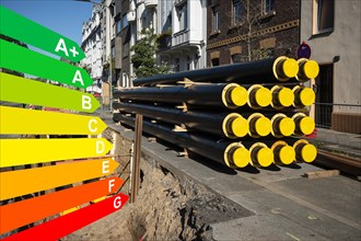 A stack of new pipes for district heating at a construction site, graphic with energy efficiency