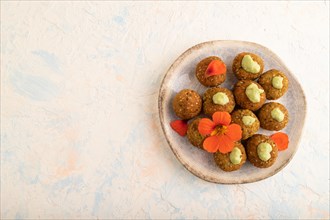 Falafel with guacamole on white concrete background. Top view, flat lay, copy space