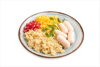 Mixed quinoa porridge, sweet corn, pomegranate seeds and small sausages isolated on white