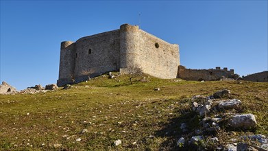 Medieval fortress in a meadow, with a light blue sky in the background, Chlemoutsi, High Medieval