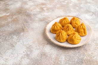 Fried manti dumplings on gray concrete background. Side view, copy space